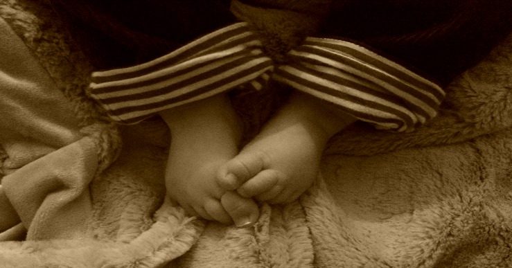 A sepia photograph of some small baby feet _ An open letter to our first baby _ Mrs H's favourite things