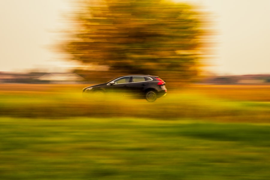 car driving past a tree with motion blur